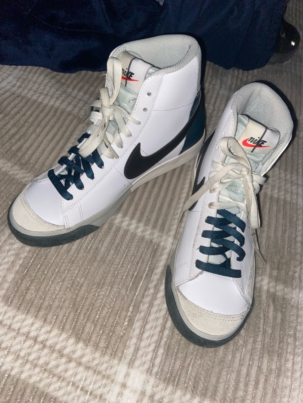 Nike White High-Top Sneakers with Black Swoosh and Teal Heel